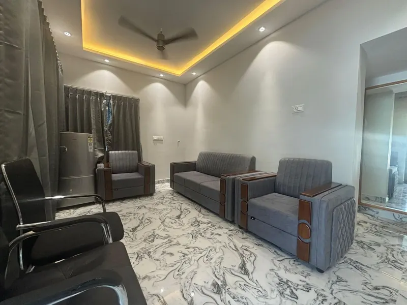 Suite living room with sofa seating and a refrigerator at Sai Grand Resorts, Kumbakarai