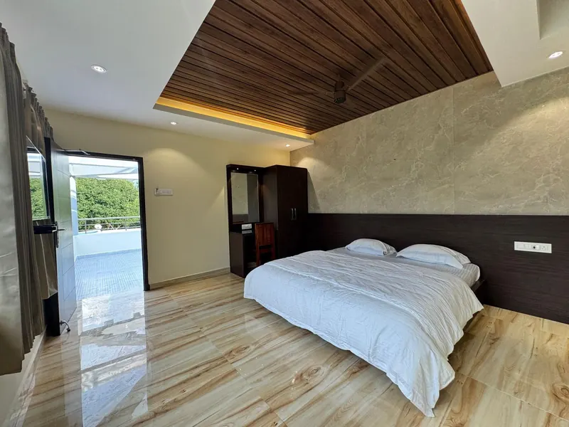 Premium room with a door opening onto the pool deck at Sai Grand Resorts, Kumbakarai